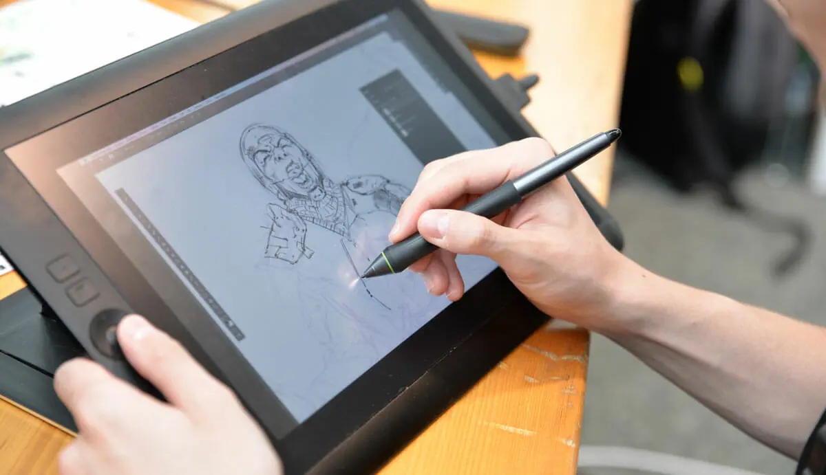 person drawing using digital tab